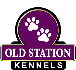 a purple sign with white paw prints